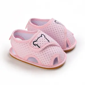 Detail view of pink baby sandals with cartoon bear embroidery and mesh fabric.