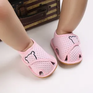 Detailed macro view of pink breathable mesh baby sandals featuring a cute bear pattern