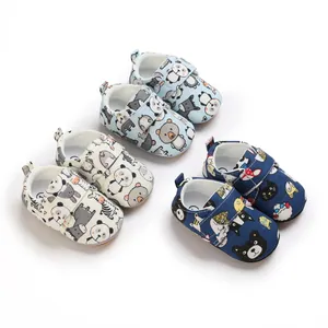 Three pairs of cartoon baby walking shoes with soft soles and velcro straps in various colors