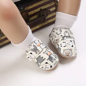 Close-up of baby walking shoes with cute cartoon animal prints and easy velcro strap