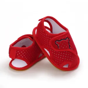 Detailed side view of red mesh baby walking sandals with cartoon bear patch