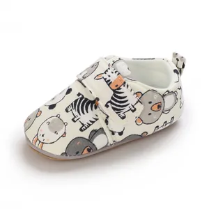 Detail of soft-soled baby walking shoe featuring cute zebra and bear cartoon prints.