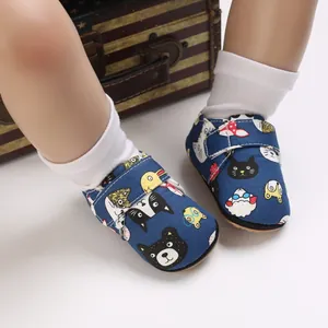 Close-up detail of blue cartoon baby walking shoes with adjustable velcro straps