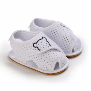 Detail view of white breathable baby walking sandals with cute bear embroidery