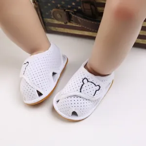 Close-up of white baby sandals with cute bear embroidery and breathable mesh