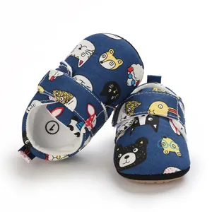 Detail view of navy blue infant pre-walker shoes featuring colorful cartoon animal patterns