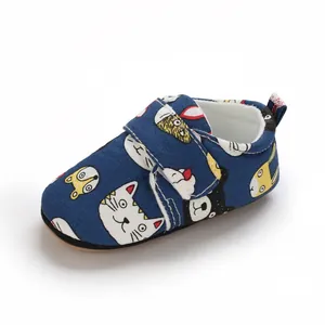Detailed view of dark blue cartoon print infant walking shoe with velcro strap