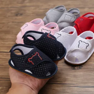 Detailed view of soft-sole infant walking sandals featuring cartoon bear design