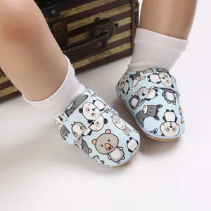 Close-up of baby walking shoes with cute cartoon animal patterns and soft soles