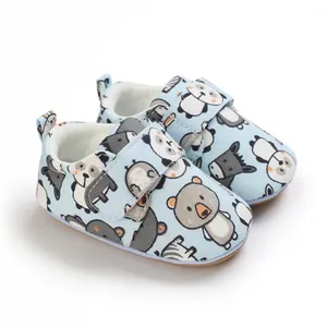 Detailed view of soft-sole baby walking shoes with cute animal prints and velcro strap