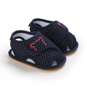 Detail view of navy blue polka dot baby walking sandals with soft rubber anti-slip soles