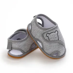 Detailed view of grey baby cartoon sandals with soft rubber soles for infant pre-walkers.