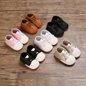 Detailed view of colorful soft-soled infant walking shoes for babies on wood background
