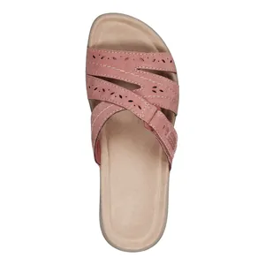 Top view of pink women's slide sandals with laser-cut patterns and platform sole.