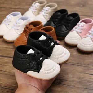 Close-up of soft-sole baby walking shoes in black and white with color options behind