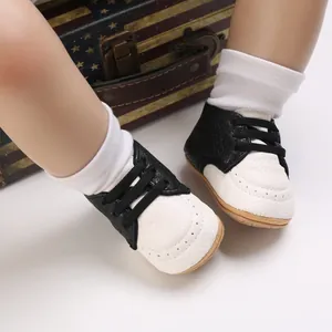 Detail view of black and white baby walking shoes with soft rubber soles