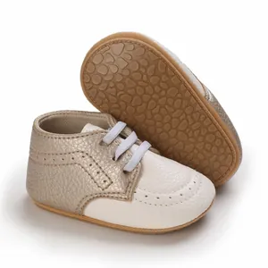 Detail view of non-slip rubber sole and champagne gold leather baby walking shoes
