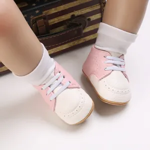 Detail shot of pink and white infant toddler shoes with soft non-slip rubber soles.