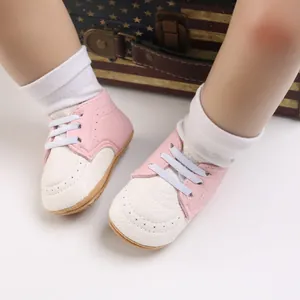 Detail of pink and white baby walking shoes with anti-slip soft rubber soles