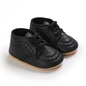Close-up of black textured leather baby walker shoes with non-slip soft soles