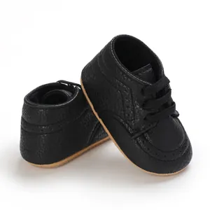 Detailed view of black soft-soled infant walking shoes with anti-slip rubber base