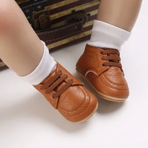 Close-up of brown faux leather baby pre-walker shoes with soft anti-slip soles