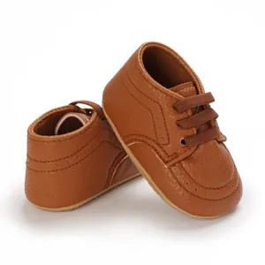 Detailed view of brown faux leather baby toddler shoes with anti-slip soft soles.