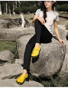Close-up of yellow five-finger outdoor wading shoes worn by a model in a natural park setting