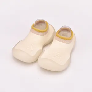 Detailed view of breathable beige baby sock shoes with flexible soft soles