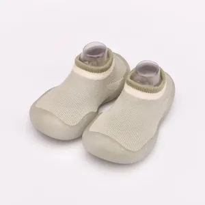 Detailed view of sage green breathable knitted baby sock shoes with flexible soft rubber soles