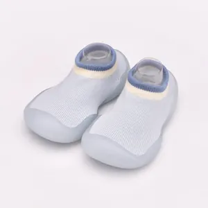 Detailed view of breathable light blue baby sock shoes with soft non-slip soles.