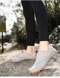 Close-up view of gray and orange water shoes worn during an outdoor hiking activity