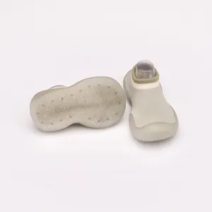 Close-up of non-slip rubber sole and breathable knit on baby walking sock shoes.