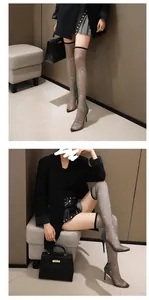 Close-up of rhinestone mesh over-the-knee boots with pointed toe and stiletto high heels