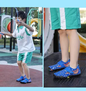 Close-up of blue patterned children's water shoes worn by a boy on an outdoor playground