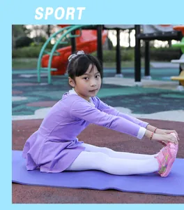 Young girl stretching outdoors in pink barefoot water shoes on a purple yoga mat