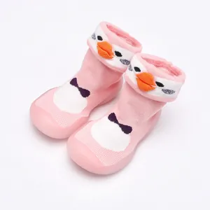 Gros plan de chaussures chaussettes bébé roses avec semelles en caoutchouc souples.