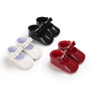Three pairs of baby girl Mary Jane shoes in white, black, and red with bow detail