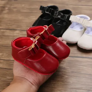 Close-up view of red baby princess walker shoes featuring elegant bow detail and soft soles