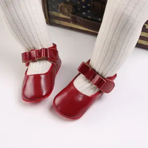 Close-up detail of red soft-sole baby girl princess shoes with bow for 0-1 year old infants