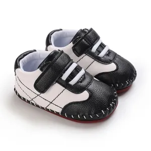 Primo piano di scarpe da camminata per neonati in pelle PU bianca e nera