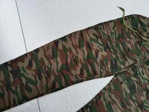 Close-up of men's camouflage sports pants featuring ribbed knee stitching and drawstring.