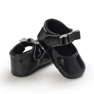 Detail view of black baby girl princess walking shoes with a cute bow decoration
