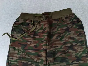 Close-up of men's camouflage joggers with drawstring waist and striped leg detail