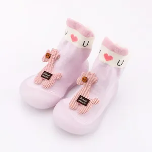 Detail view of pink cartoon giraffe baby walker shoes with soft anti-slip rubber soles