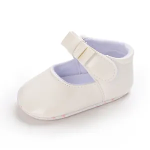 Side view of cream white baby girl walker shoe with bow detail and velcro strap.