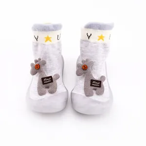 Front view of cute grey baby sock shoes featuring soft rubber soles and plush deer