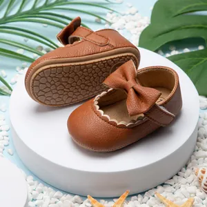 Gedetailleerd overzicht van bruine baby prinsessenschoenen met strik en rubberen zool