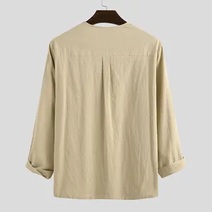 Rear view of a men's beige cotton linen long sleeve shirt on a wooden hanger