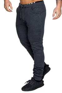 Detail view of men's dark grey moto joggers with ribbed knee panels for sports.